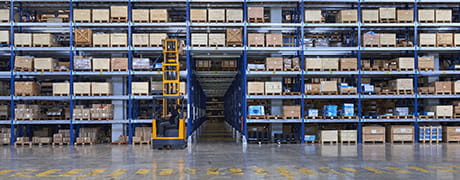 Forklift moving boxes in
                a warehouse